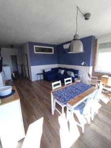 a living room with a table and chairs and a couch at Una ventana al Mar en Málaga in Málaga