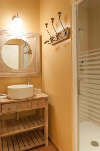 a bathroom with a sink and a mirror and a shower at Domaine de la Courbe Hôtel & Spa in Le Lude