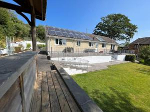 a house with solar panels on the roof at Berllan Deg in Cardigan