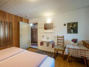 a bedroom with a bed and a sink and a mirror at Haus Sabine Braunegger in Kaltenbach