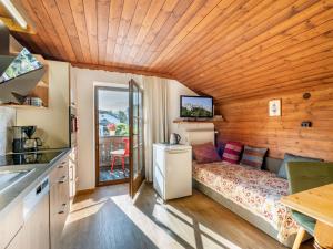 a small bedroom with a bed in a wooden room at Haus Sabine Braunegger in Kaltenbach