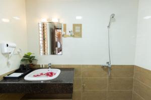 a bathroom with a sink and a shower at Royal Hotel Sài Đồng - Long Biên in Hanoi