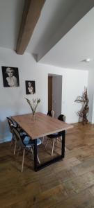 a wooden table in a room with chairs at La Bombonera del Berguedà in Sant Jordi de Cercs