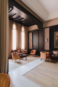a lobby with couches and chairs in a building at Kenzi Menara Palace & Resort in Marrakech