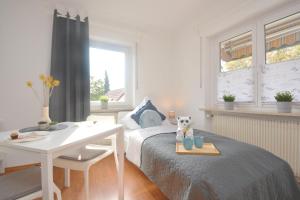 a bedroom with a bed and a table and a desk at BA02-RI Apartment bei Bamberg in Reckendorf