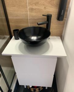 a black sink on a white counter in a bathroom at Studio H&M: chic*10 mins Disney*30 mins Paris*wifi in Bussy-Saint-Georges