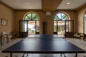 una mesa de ping pong en una habitación con ventanas en Apartment Alhamar Beach Mijas, en Mijas