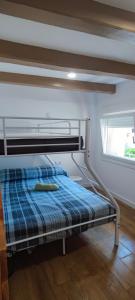 a bunk bed in a room with a window at La Bombonera del Berguedà in Sant Jordi de Cercs