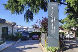 a sign for a house on a street at Hotel Best Osuna in Madrid +26 photos
