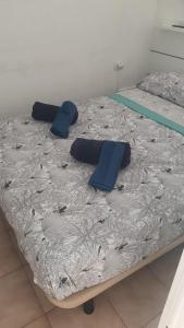 a bed with blue pillows on top of it at DORY HOUSE LOS CRISTIANOS in Los Cristianos +31 photos