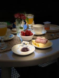 a table with plates of food and fruit on it at Casa Andes in San Pedro de Atacama +24 photos