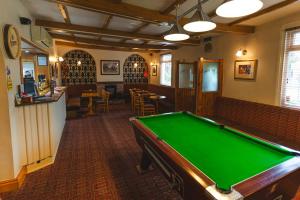 a pool table in a room with a bar at Eyre arms 