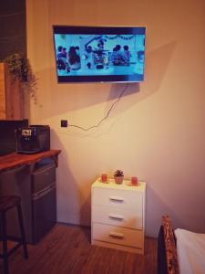 a flat screen tv on the wall of a room at Apartamenty Toskania No.2 in Poznań