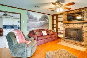 a living room with a couch and a fireplace at Charming Lake Charles Home with Patio and Grill in Lake Charles