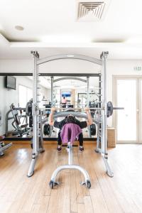 a person in a gym doing a barbellstack at Kenzi Menara Palace & Resort in Marrakesh
