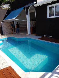 a swimming pool in front of a house at Maison charmante avec piscine à Petit-Bourg. in Petit-Bourg +15 photos