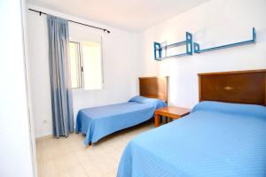 a bedroom with two beds and a window at 2 bedrooms apartement at Denia 300 m away from the beach with shared pool and furnished terrace in Denia