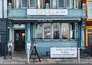 a building with a now serving food sign in front of it at The Royal Bar & Shaker in Morecambe