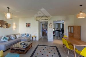 a living room with a couch and a table at Ladybird - Veranda Beach House in Hurghada