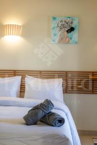 a stuffed animal laying on top of a bed at Ladybird - Veranda Beach House in Hurghada