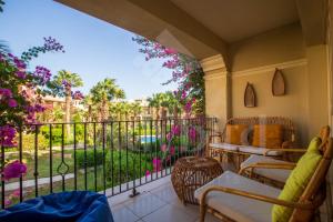 a balcony with a view of a garden at Ladybird - Veranda Beach House in Hurghada