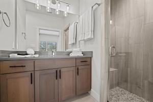 a bathroom with a sink and a shower at Longhorn Haus in Fredericksburg +27 photos