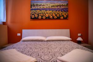 a bedroom with a bed with a painting on the wall at Casa Flavia in Rozzano
