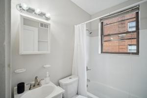 a white bathroom with a toilet and a sink at Peaceful & Perfect Private 1-br I Lennox in Philadelphia