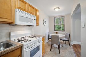a kitchen with a stove and a sink and a table at Peaceful & Perfect Private 1-br I Lennox in Philadelphia