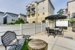 a patio with a table and chairs and an umbrella at Chic Newark Vacation Rental Patio and Fireplace! in Newark