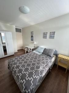 ein Schlafzimmer mit einem großen Bett und einem Tisch in der Unterkunft Apartment with city skyline in Leeuwarden