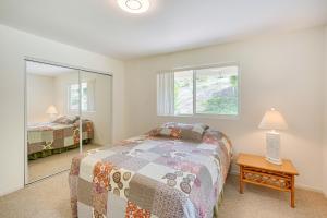 a bedroom with a bed and a mirror at Captain Cook Home on Quiet 3 Acres with Fruit Trees in Papa Bay Estates