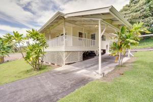 a large white house with a porch and grass at Captain Cook Home on Quiet 3 Acres with Fruit Trees in Papa Bay Estates