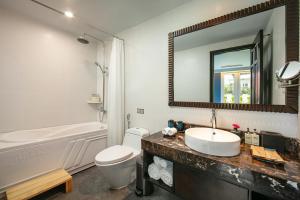 a bathroom with a sink and a toilet and a mirror at O'Gallery Premier Hotel & Spa in Hanoi