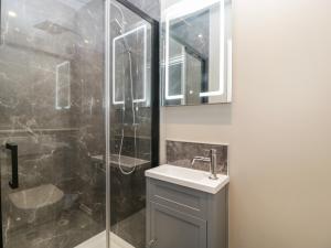 a bathroom with a sink and a glass shower at 19 Lion Street in Hereford