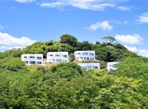 a house on top of a hill with trees at Surf Ranch Resort - Popoyo in Popoyo