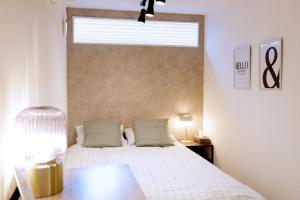 a bedroom with a large white bed with a window at 夢の舎 Asakusa Horizon Bleu in Tokyo