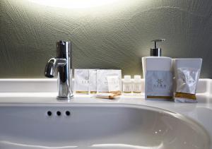 a bathroom sink with a faucet and other items on it at Casa MiMa in Pescara +18 photos
