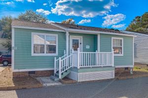 a green house with a white porch at 3rd Avenue Oasis in Myrtle Beach