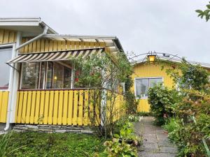 żółty dom z żółtym płotem przed nim w obiekcie Well-equipped holiday home in Varnamo w mieście Värnamo