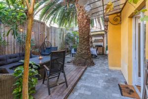 une terrasse avec une table et un palmier dans l'établissement La Maison des Huîtres, à Arcachon