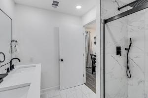 a white bathroom with a shower and a sink at Corpus Christi Charm in Corpus Christi +19 photos