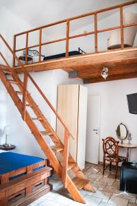 a loft bed with a staircase in a room at B&B Epoche' in Naples