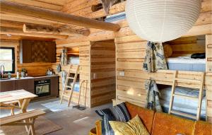 Cabaña de madera con sala de estar con sofá y cocina en Amazing Home In Kittelfjll With Ethernet Internet en Kittelfjäll