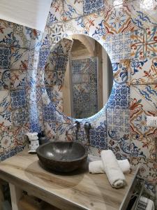 La salle de bains est pourvue d'un lavabo et d'un miroir. dans l'établissement SaLò Apartments, à Manfredonia