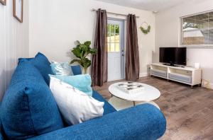 a living room with a blue couch and a tv at 1034 3rd Ave SW Unit B in Largo