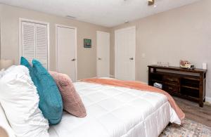 a bedroom with a white bed and a desk at 1034 3rd Ave SW Unit B in Largo