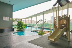 a swimming pool with a slide in a building at BBHomes at Casa Residency KL in Kuala Lumpur