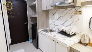 a kitchen with a sink and a counter top at Royal Suites Studio 15th Floor - Citra Plaza Nagoya Apartment in Nagoya