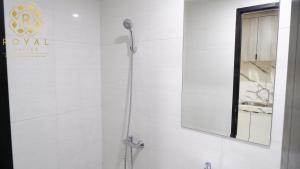 a shower in a bathroom with a mirror at Royal Suites Studio 15th Floor - Citra Plaza Nagoya Apartment in Nagoya +5 photos